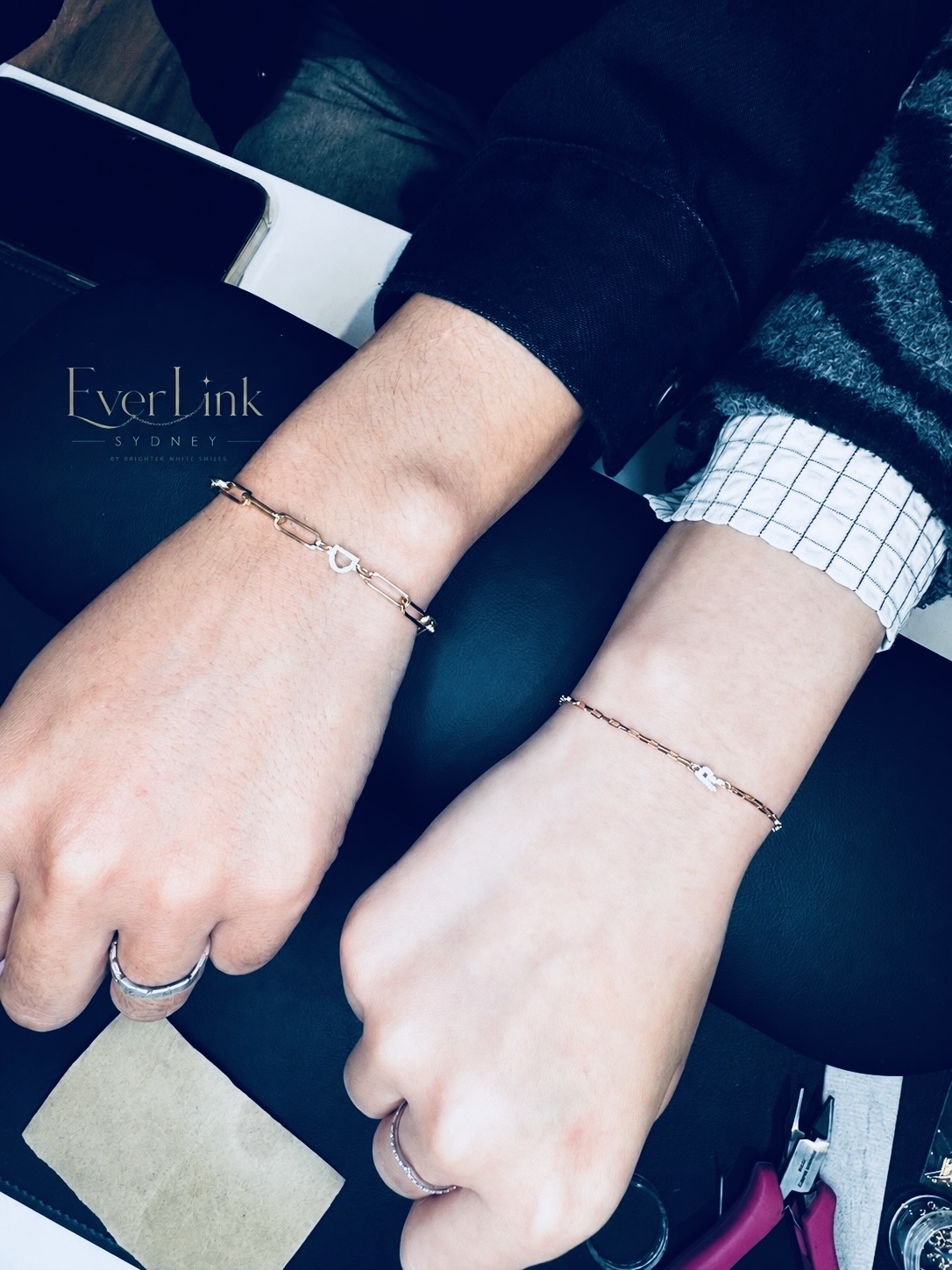 Two clients wearing personalised permanent bracelets together
